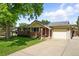 Well-maintained brick home with an attached garage and long driveway at 470 S Queen St, Lakewood, CO 80226