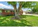 Brick home with a beautiful, shady yard and attached garage in a residential neighborhood at 470 S Queen St, Lakewood, CO 80226