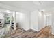 Hallway leading to the living room featuring updated flooring, neutral walls, and modern lighting creating a cohesive design at 470 S Queen St, Lakewood, CO 80226