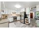 Bright kitchen featuring stainless steel appliances, white cabinetry, and updated countertops for a modern appeal at 470 S Queen St, Lakewood, CO 80226