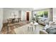 Open-concept living room featuring hardwood floors, a dining area, and a comfortable seating arrangement at 470 S Queen St, Lakewood, CO 80226
