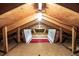 Attic space with wooden beams and a ceiling light; shows potential for storage or renovation at 7296 Quivas St, Denver, CO 80221