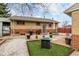 A well maintained backyard includes an outdoor grill, fire pit, patio furniture and lots of room to relax at 7296 Quivas St, Denver, CO 80221