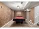 Basement with a red felt pool table and carpeted floor, ready for entertainment at 7296 Quivas St, Denver, CO 80221