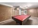 Basement features a red felt pool table with carpeting, perfect for recreation at 7296 Quivas St, Denver, CO 80221