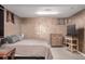 Cozy bedroom featuring textured walls, carpet floors, dresser, and television on a stand at 7296 Quivas St, Denver, CO 80221