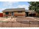 An attractive brick home featuring decorative rock landscaping, a security door, and an attached carport at 7296 Quivas St, Denver, CO 80221