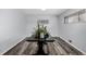 A flex room with a dining table, wooden floors, and neutral walls at 7296 Quivas St, Denver, CO 80221