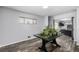 A flex room featuring modern wood-style flooring, a dining table, and natural light from multiple windows at 7296 Quivas St, Denver, CO 80221