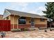 Charming brick home featuring decorative rock landscaping, a front security door, and a classic design at 7296 Quivas St, Denver, CO 80221