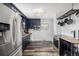 Bright kitchen featuring stainless steel appliances, navy cabinets, and stylish flooring throughout at 7296 Quivas St, Denver, CO 80221