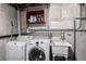 Laundry room featuring a washing machine, dryer, and utility sink at 7296 Quivas St, Denver, CO 80221