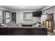 A living room featuring a large sectional couch, a television, and bright natural light at 7296 Quivas St, Denver, CO 80221