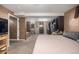 Spacious bedroom with walk-in closet and attached bathroom featuring dark wood details at 7296 Quivas St, Denver, CO 80221