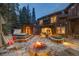 Outdoor living on a stone patio with a fire pit and hot tub, perfect for relaxing or entertaining under the stars at 215 Royal Tiger Rd, Breckenridge, CO 80424