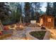Enjoy the outdoors on this expansive patio featuring a fire pit, hot tub, lounge chairs, and lush landscaping at 215 Royal Tiger Rd, Breckenridge, CO 80424
