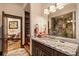 Elegant bathroom with granite counters, a large mirror reflecting a glass enclosed shower, and stairway access at 215 Royal Tiger Rd, Breckenridge, CO 80424