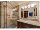 The renovated bathroom offers a glass-enclosed shower and granite-topped vanity with under-mount sink at 215 Royal Tiger Rd, Breckenridge, CO 80424