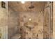 Walk-in shower with stone-look tile, a bench, and dual showerheads in this contemporary bathroom at 215 Royal Tiger Rd, Breckenridge, CO 80424
