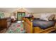 Bright bedroom showcasing twin beds, a cozy sitting area, and a window with views of the wooded landscape at 215 Royal Tiger Rd, Breckenridge, CO 80424