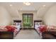Charming bedroom featuring symmetrical design, natural lighting, and twin beds with decorative pillows and a center table at 215 Royal Tiger Rd, Breckenridge, CO 80424