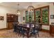 Formal dining room with a large table, decorative lighting, and views of the exterior landscape at 215 Royal Tiger Rd, Breckenridge, CO 80424