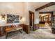Entryway with natural stone floors, wooden trim, and artwork at 215 Royal Tiger Rd, Breckenridge, CO 80424