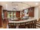 A chef's kitchen with stone counter seating, custom cabinets, stainless appliances, and natural light at 215 Royal Tiger Rd, Breckenridge, CO 80424