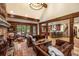 Open-concept living room showcasing a stone fireplace, comfortable seating, and hardwood floors at 215 Royal Tiger Rd, Breckenridge, CO 80424