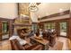 Inviting living room featuring a stone fireplace with raised hearth, plush seating, and scenic views at 215 Royal Tiger Rd, Breckenridge, CO 80424