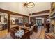 Spacious living area with hardwood floors, exposed beams, stone fireplace, and view of the dining room at 215 Royal Tiger Rd, Breckenridge, CO 80424