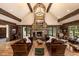 Spacious living room with a grand stone fireplace, vaulted ceilings, and exposed wooden beams at 215 Royal Tiger Rd, Breckenridge, CO 80424