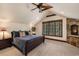A luxurious main bedroom with a stone fireplace and a large window showcasing outdoor views at 215 Royal Tiger Rd, Breckenridge, CO 80424