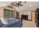 The main bedroom offers a stone fireplace, vaulted ceilings and large windows at 215 Royal Tiger Rd, Breckenridge, CO 80424