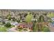 Areal view of suburban brick home with mature trees and lush green landscaping at 6919 S Valentia St, Centennial, CO 80112