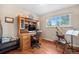 Bedroom with wooden floors, large desk, and natural light from a window at 6919 S Valentia St, Centennial, CO 80112
