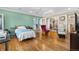 Comfortable bedroom with hardwood floors and views into dining area at 6919 S Valentia St, Centennial, CO 80112