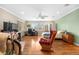 Spacious bedroom with a desk, rocking chair, hardwood floors, and a ceiling fan at 6919 S Valentia St, Centennial, CO 80112
