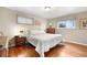 Cozy bedroom with hardwood floors, comfortable bed, and natural light at 6919 S Valentia St, Centennial, CO 80112