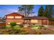 Charming brick home featuring manicured lawn and stone walkway to the front door at 6919 S Valentia St, Centennial, CO 80112