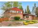 Two-story brick home with a well-maintained lawn and landscaping at 6919 S Valentia St, Centennial, CO 80112