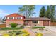 Charming brick home featuring manicured lawn and stone walkway to the front door at 6919 S Valentia St, Centennial, CO 80112