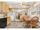 Spacious kitchen featuring vintage details, wooden cabinets, and adjacent dining area at 6919 S Valentia St, Centennial, CO 80112