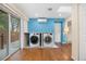 Laundry room with new washer and dryer, sliding glass door and skylight at 6919 S Valentia St, Centennial, CO 80112