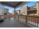 Covered wooden deck with railings offering a comfortable outdoor living space and neighborhood views at 9536 Richfield St, Commerce City, CO 80022