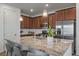 Modern kitchen with granite countertops, stainless steel appliances, and stylish pendant lighting at 9536 Richfield St, Commerce City, CO 80022