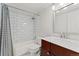 Bright bathroom featuring a modern vanity and a shower with subway tile surround at 1160 S Monaco Pkwy # 6, Denver, CO 80224