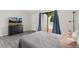 Bedroom with wood floors and sliding glass doors leading to a private balcony at 1160 S Monaco Pkwy # 6, Denver, CO 80224