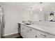 Bright kitchen boasts stainless steel appliances, white cabinetry, and sleek countertops at 1160 S Monaco Pkwy # 6, Denver, CO 80224
