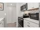 Modern kitchen with stainless steel appliances, white cabinets, and plenty of counter space at 1160 S Monaco Pkwy # 6, Denver, CO 80224